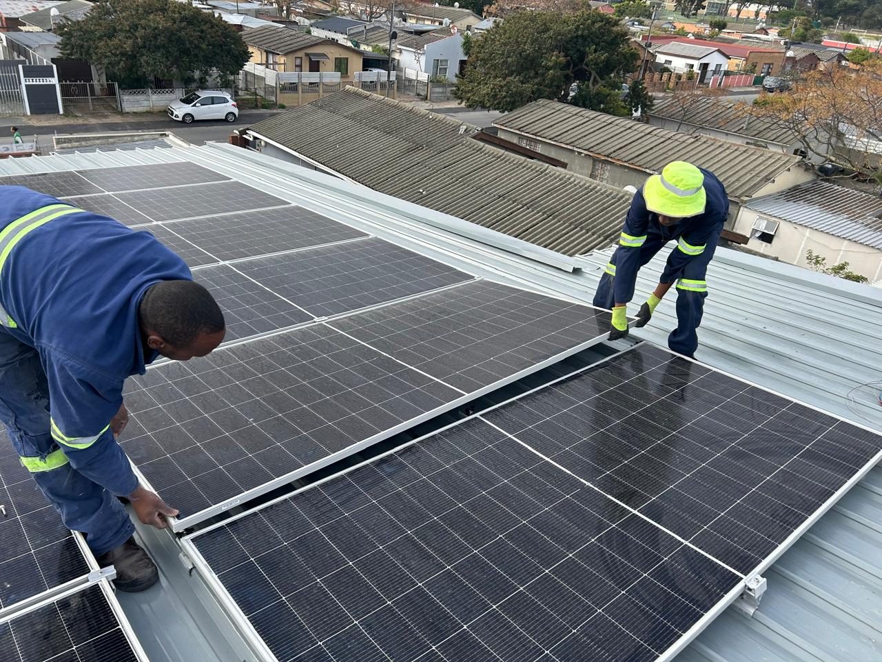 DJVD Electrical technicians installing solar panels on a Cape Town roof